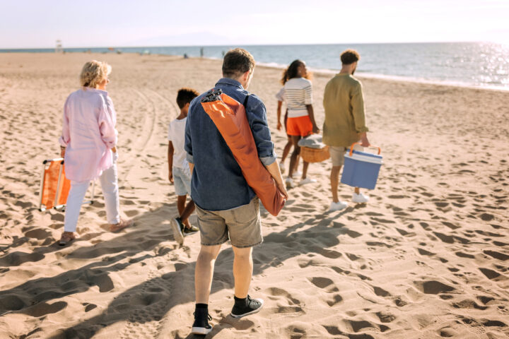 Blended families picture of a family of various ages walking along the beach.