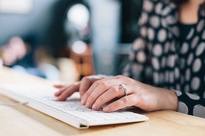 Employee monitoring lady's hands at a keyboard