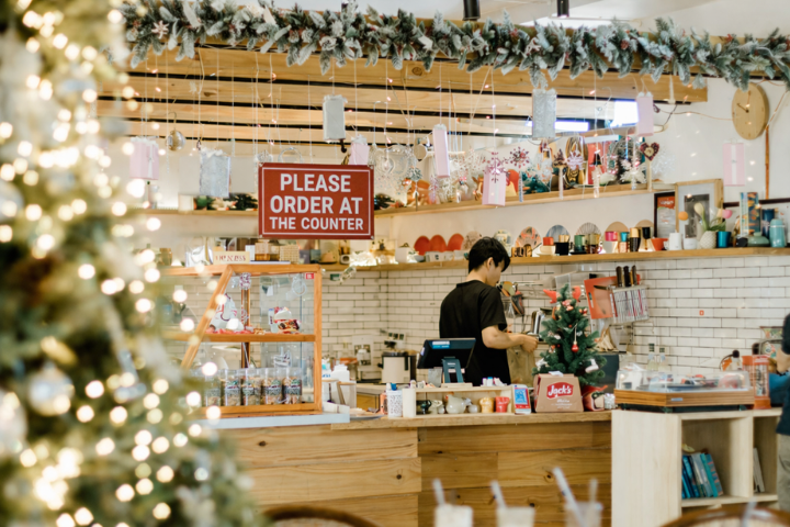 man working in shop with Christmas decorations